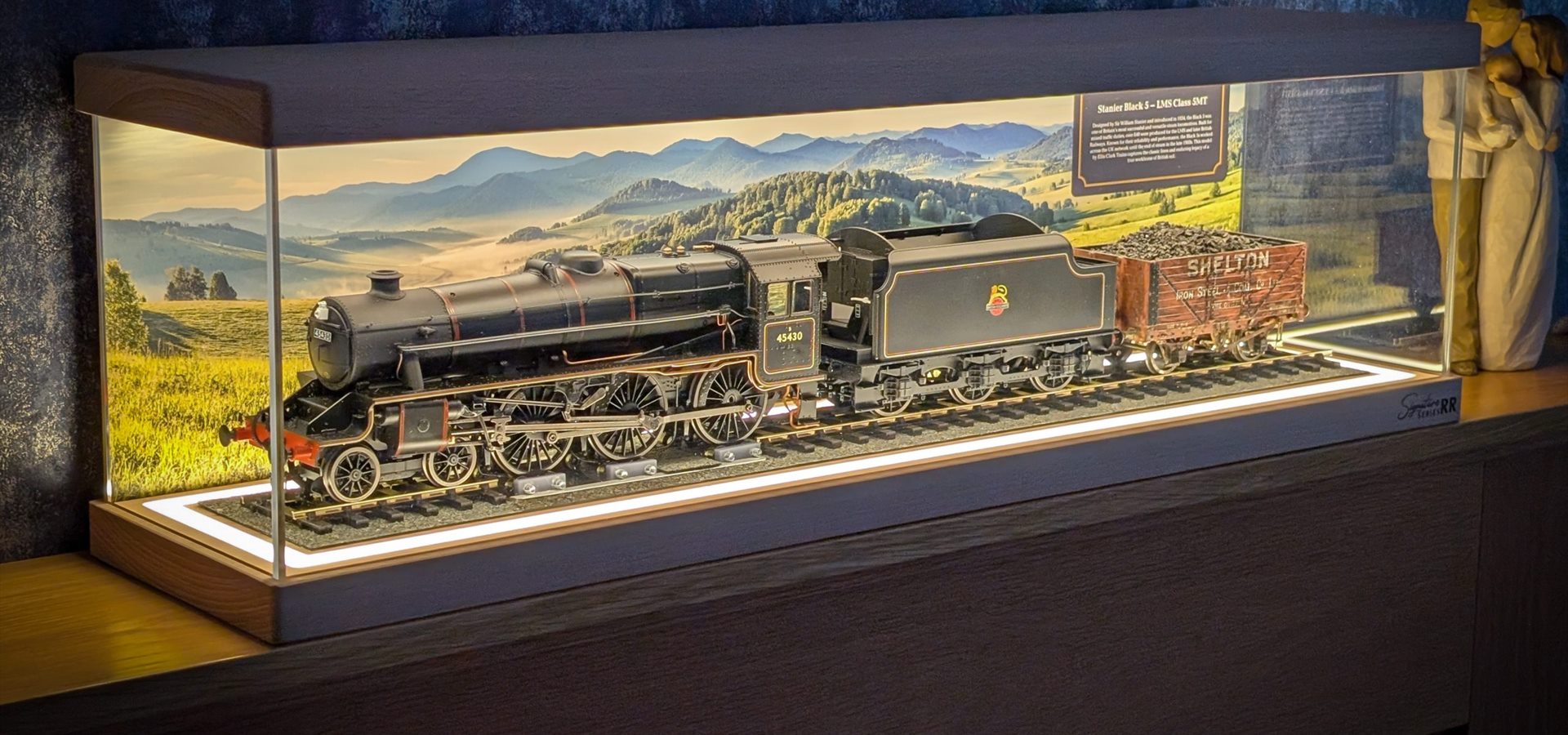 A model steam locomotive presented in a wooden DecorFab display case